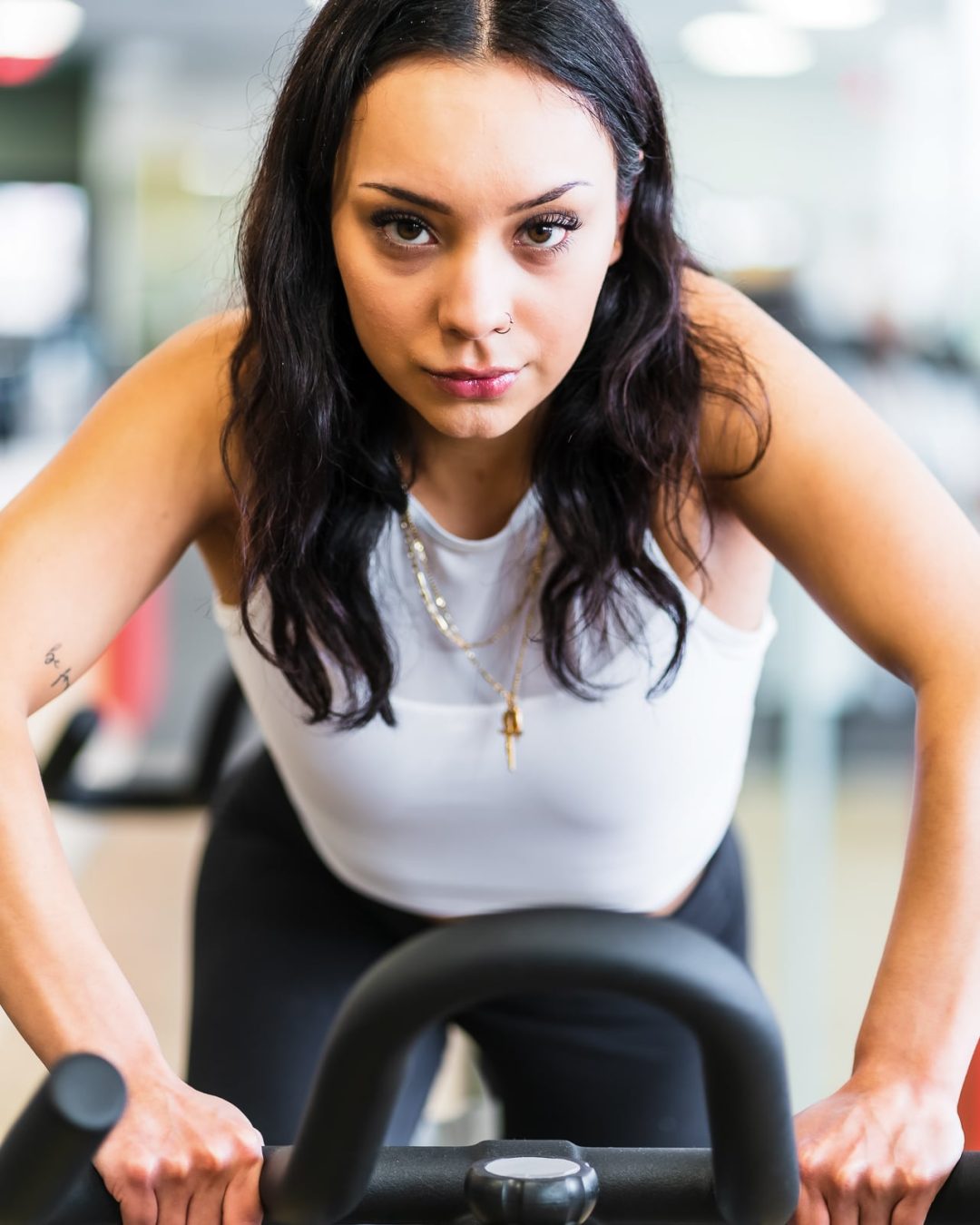 Woman riding exercise bike at Etobicoke gym GROW FItness